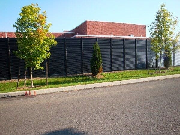 Contemporary commercial building exterior with architectural outdoor screening