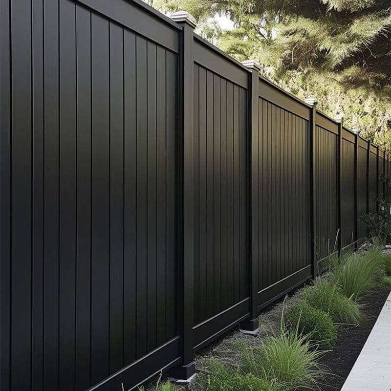 Vertical aluminum privacy fence surrounding a modern courtyard