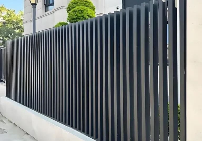 Vertical metal fence design at a contemporary architectural entrance