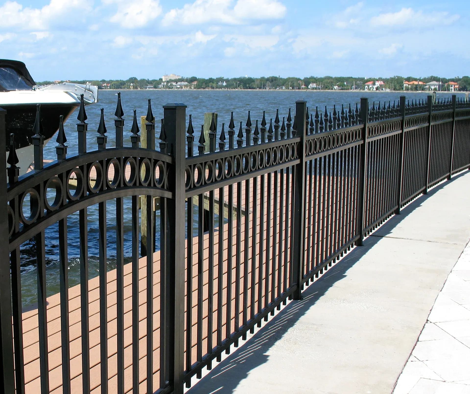 Decorative metal fence detail in an outdoor landscape setting